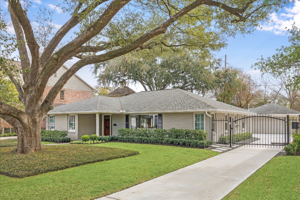 5655 Overbrook Lane Houston, TX 77056 - Photo 3 of 36 Recently poured driveway and sidewalk (2024) + electric security gate leading towards a wonderful attachd 2-car garage.