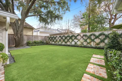 a view of a patio with table and chairs potted plants
