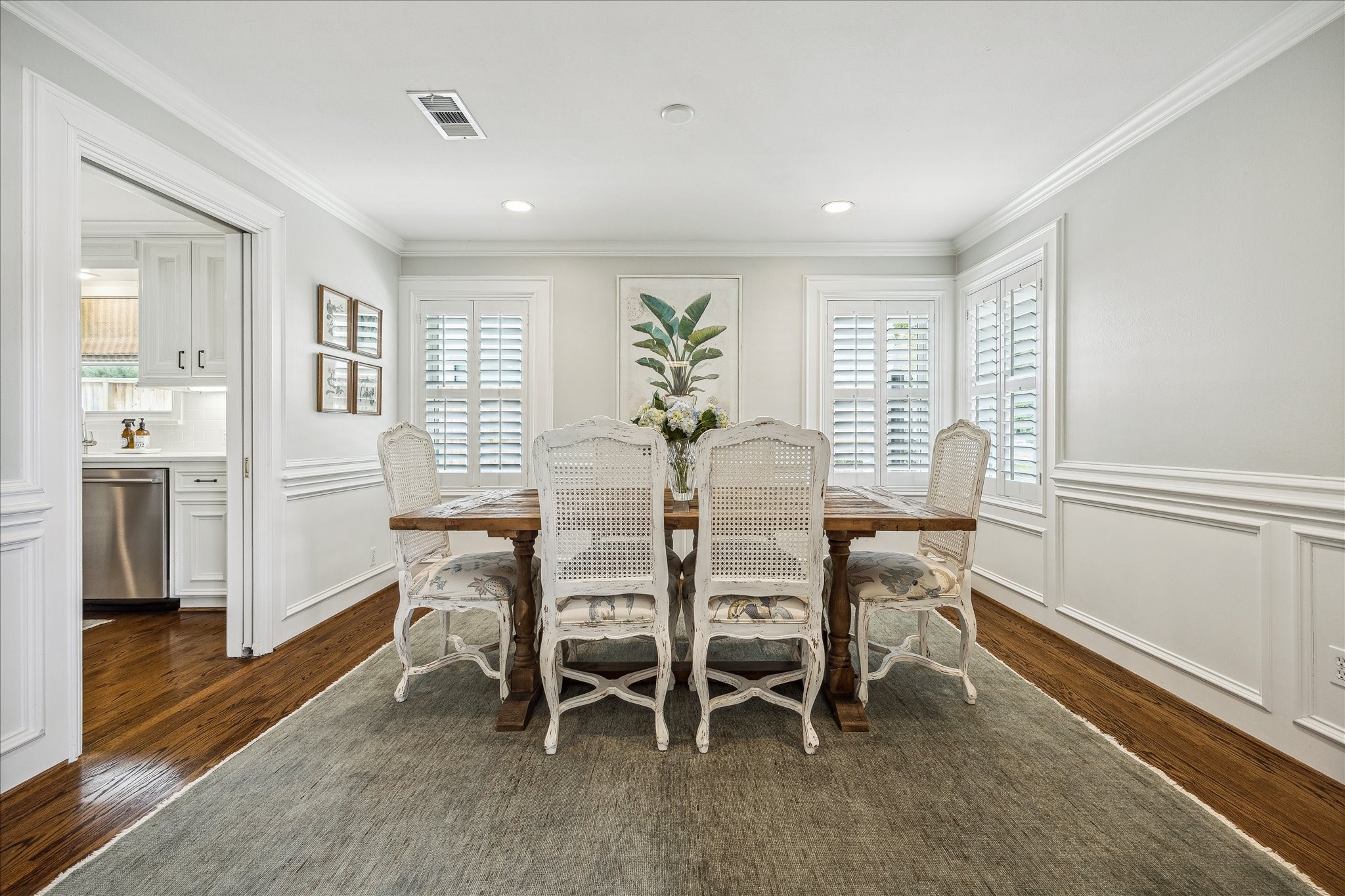 5655 Overbrook Lane Houston, TX 77056 - Photo 9 of 36 Formal dining room with plantation shutters and pocket doors leading to the kitchen.