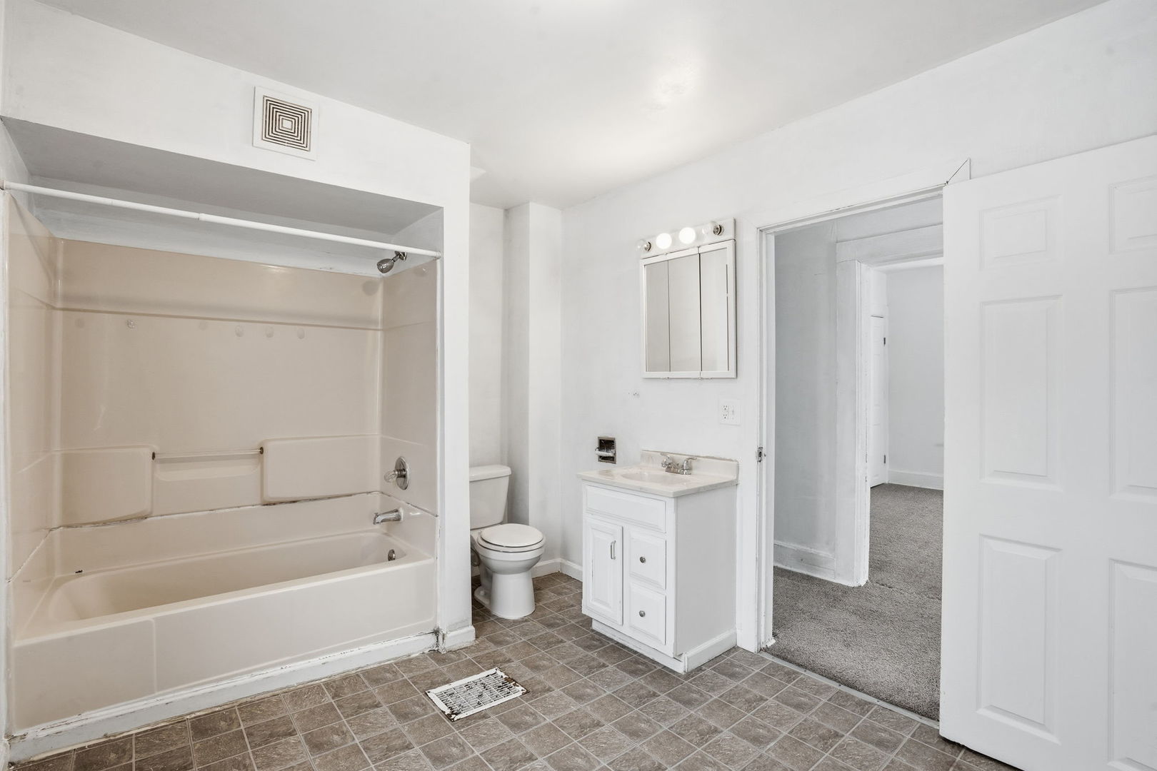 1306 17th Street Moline, IL 61265 - Photo 10 of 14 a bathroom with a bathtub toilet and a shower