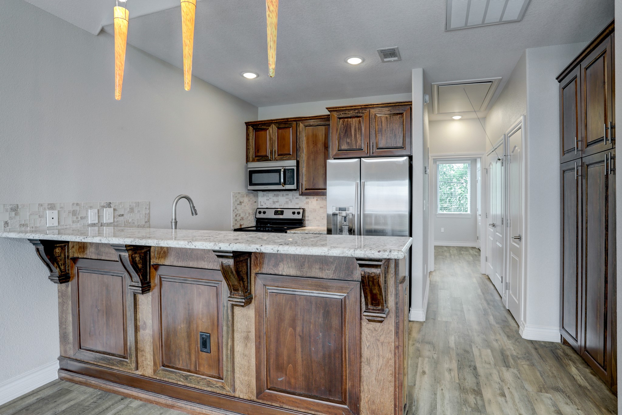 50 West 8th Street, Unit A Kemah, TX 77565 - Photo 4 of 11 a kitchen with stainless steel appliances granite countertop a sink a stove and a refrigerator