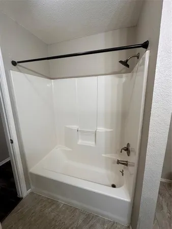 a bathroom with a toilet and a bathtub
