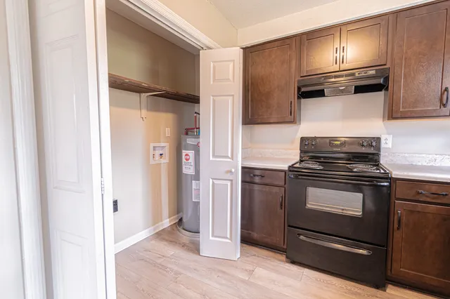a kitchen with a refrigerator stove and cabinets