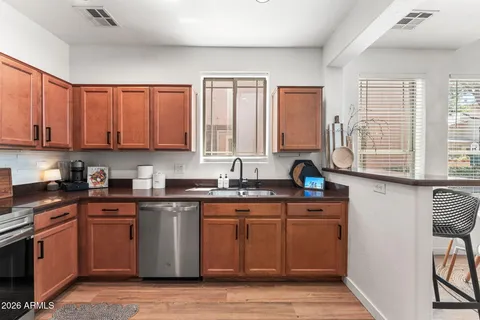 a kitchen with stainless steel appliances granite countertop a stove a sink dishwasher and cabinets