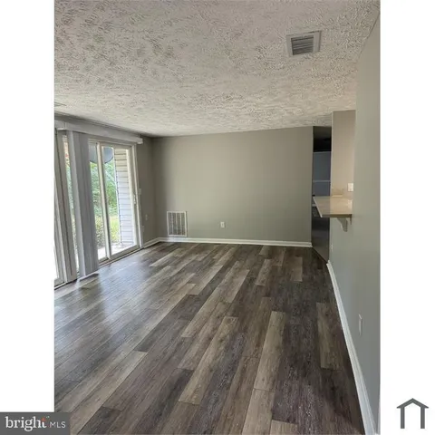 a view of hallway with wooden floor and staircase