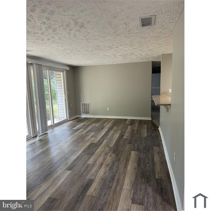 3361 Yost Lane, Unit 103 Dumfries, VA 22026 - Photo 2 of 10 a view of hallway with wooden floor and staircase