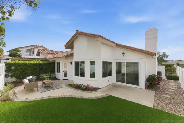 a front view of a house with a garden and yard