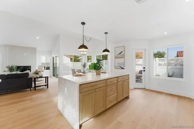 a kitchen with stainless steel appliances kitchen island granite countertop a sink a counter space and cabinets