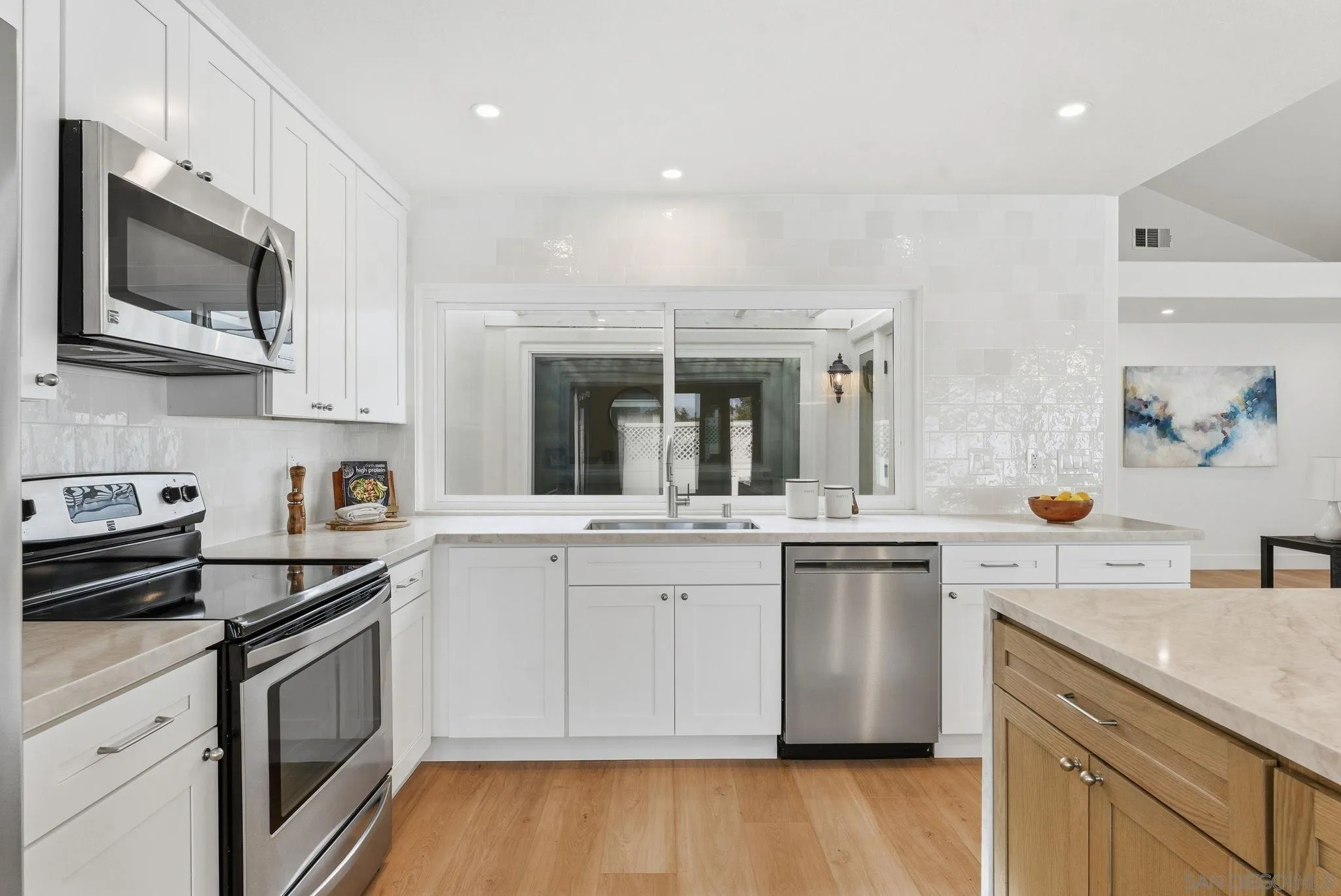 4744 Agora Way Oceanside, CA 92056 - Photo 12 of 31 a kitchen with a sink stove and cabinets