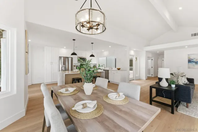 a view of a dining room with furniture a rug and wooden floor