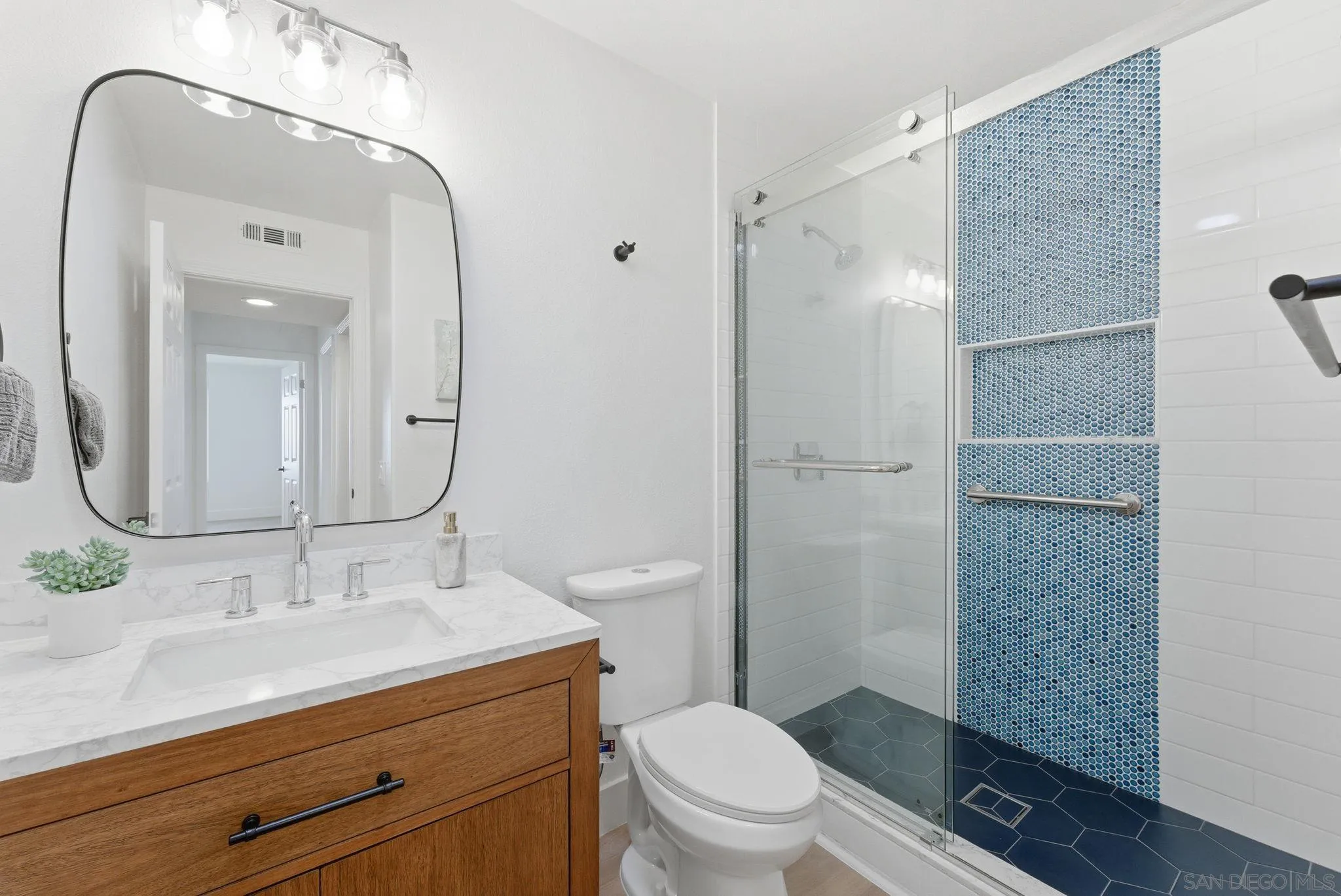 4744 Agora Way Oceanside, CA 92056 - Photo 19 of 31 a bathroom with a granite countertop sink toilet and shower