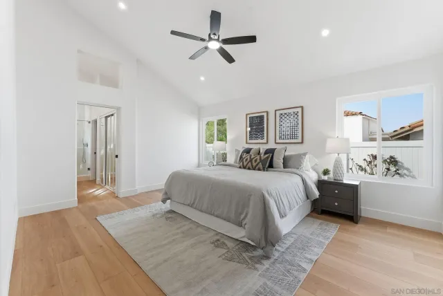 a bedroom with a large bed and a chandelier