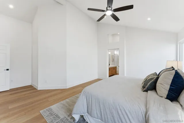 a bedroom with a bed and painting on the wall