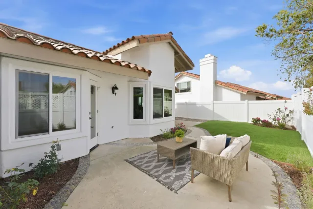a front view of a house with a garden and patio