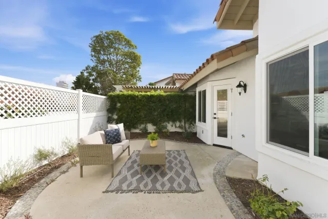 a view of a patio with table and chairs and potted plants