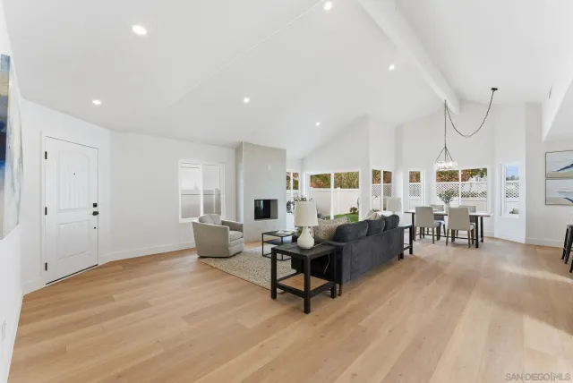 a living room with furniture and kitchen view