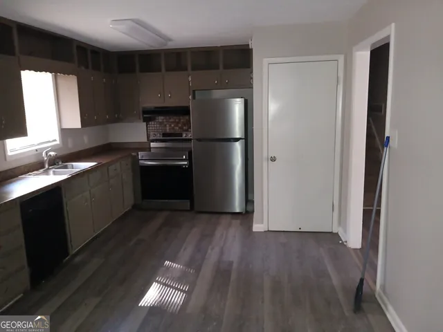 a kitchen with a refrigerator and a sink