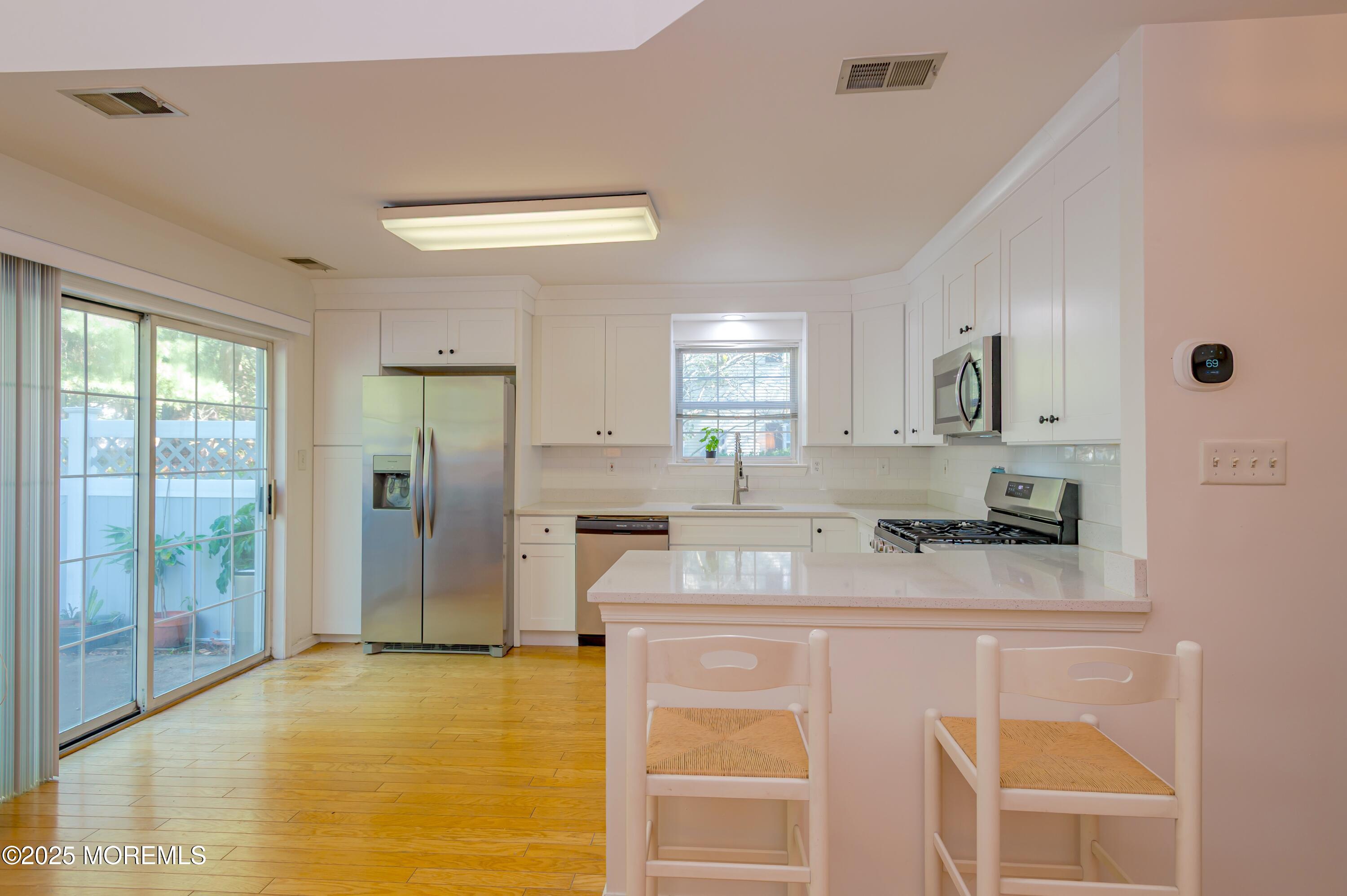 139 Tanya Circle, Unit 5506 Asbury Park, NJ 07712 - Photo 14 of 31 a kitchen with stainless steel appliances granite countertop a sink stove and refrigerator