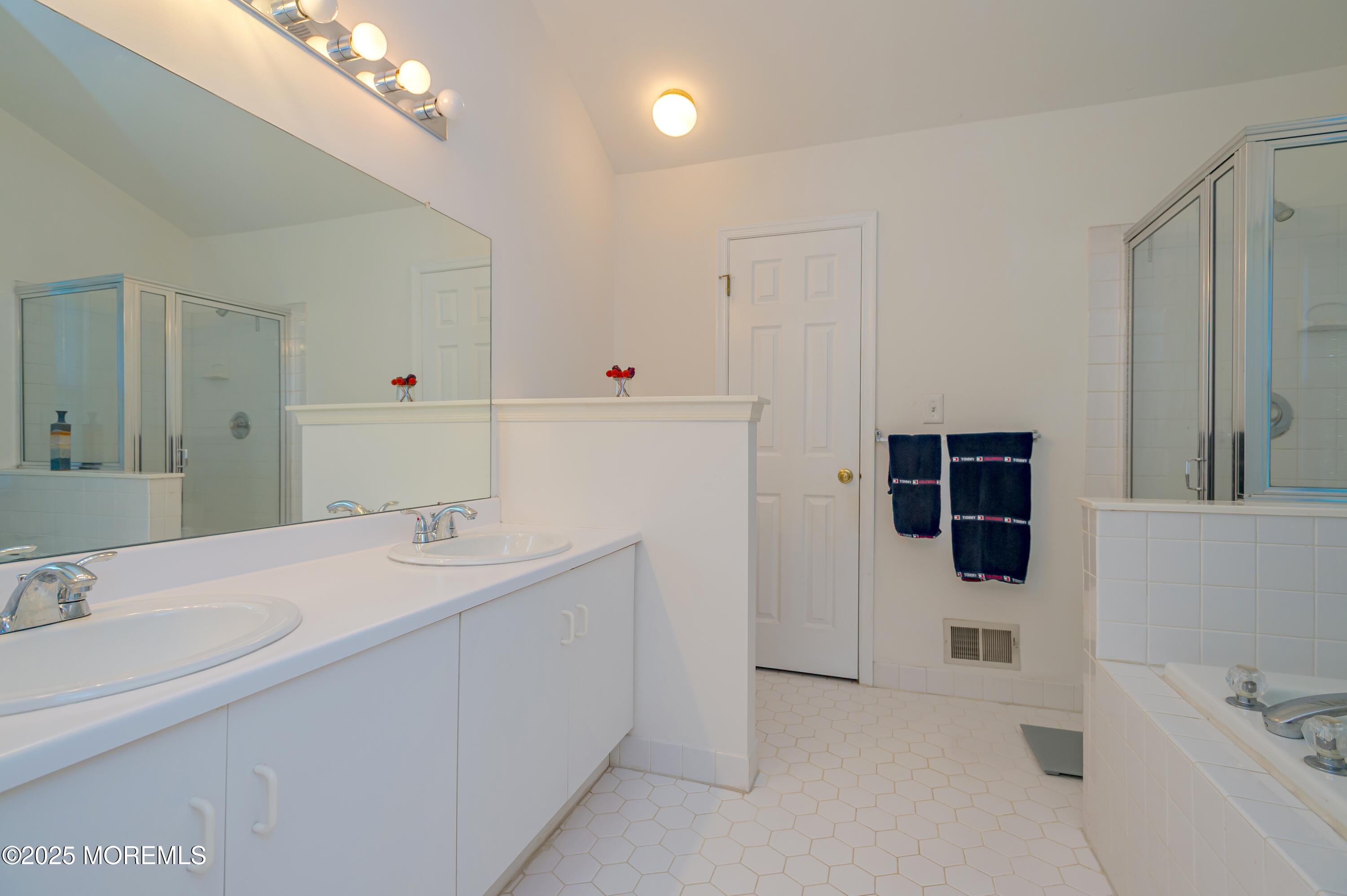 139 Tanya Circle, Unit 5506 Asbury Park, NJ 07712 - Photo 20 of 31 a bathroom with a sink and a mirror