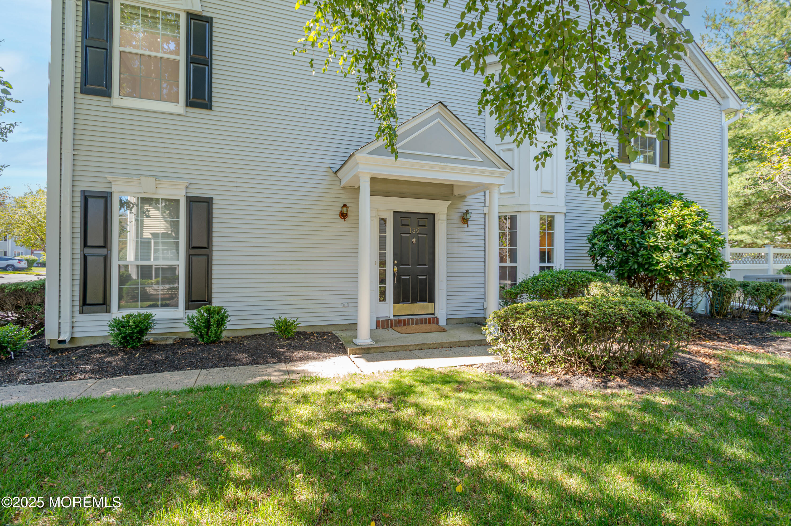 139 Tanya Circle, Unit 5506 Asbury Park, NJ 07712 - Photo 3 of 31 a front view of a house with a yard and potted plants