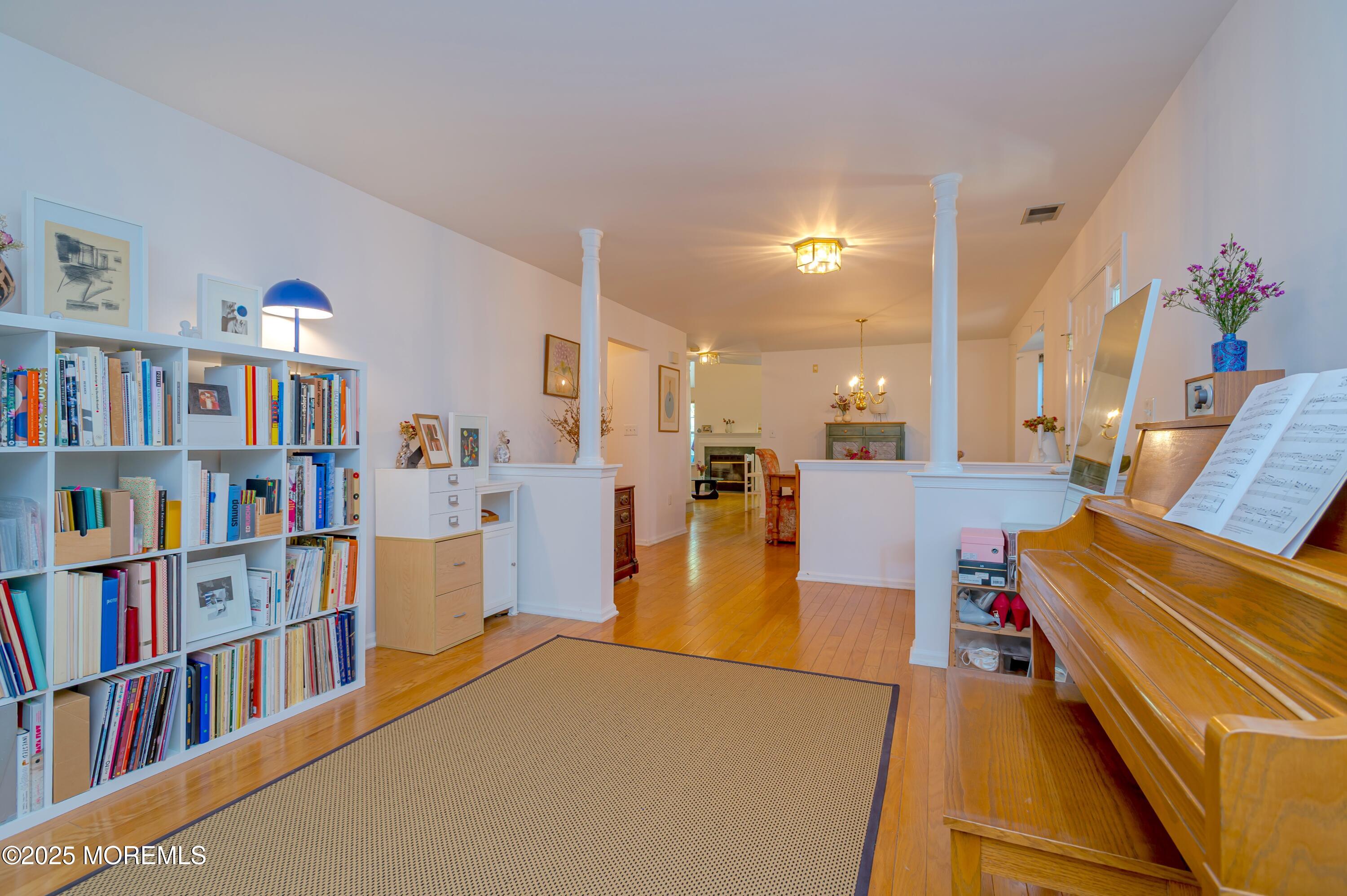 139 Tanya Circle, Unit 5506 Asbury Park, NJ 07712 - Photo 5 of 31 a living room with furniture and a book shelf