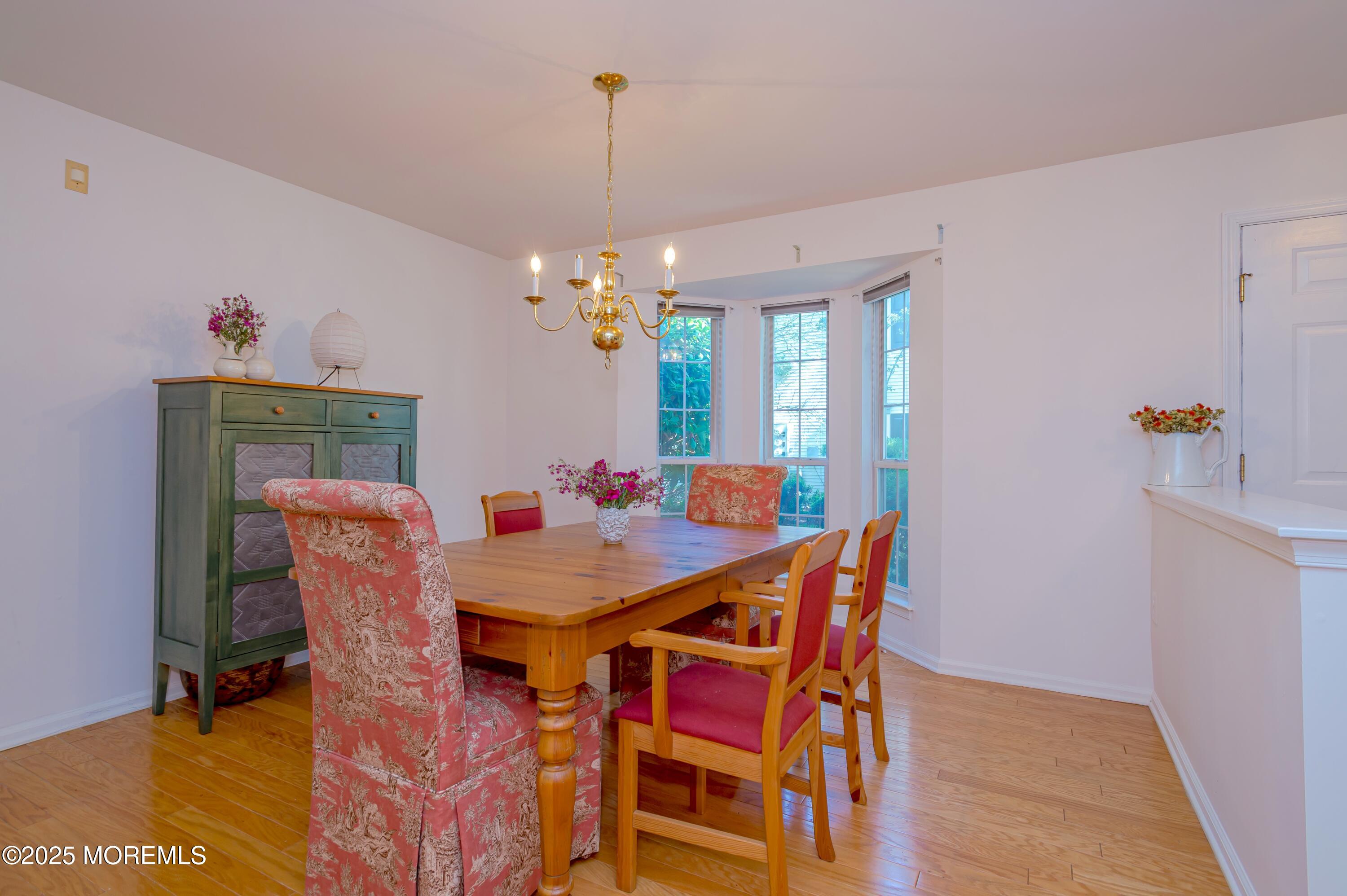 139 Tanya Circle, Unit 5506 Asbury Park, NJ 07712 - Photo 7 of 31 a view of a dining room with furniture and chandelier