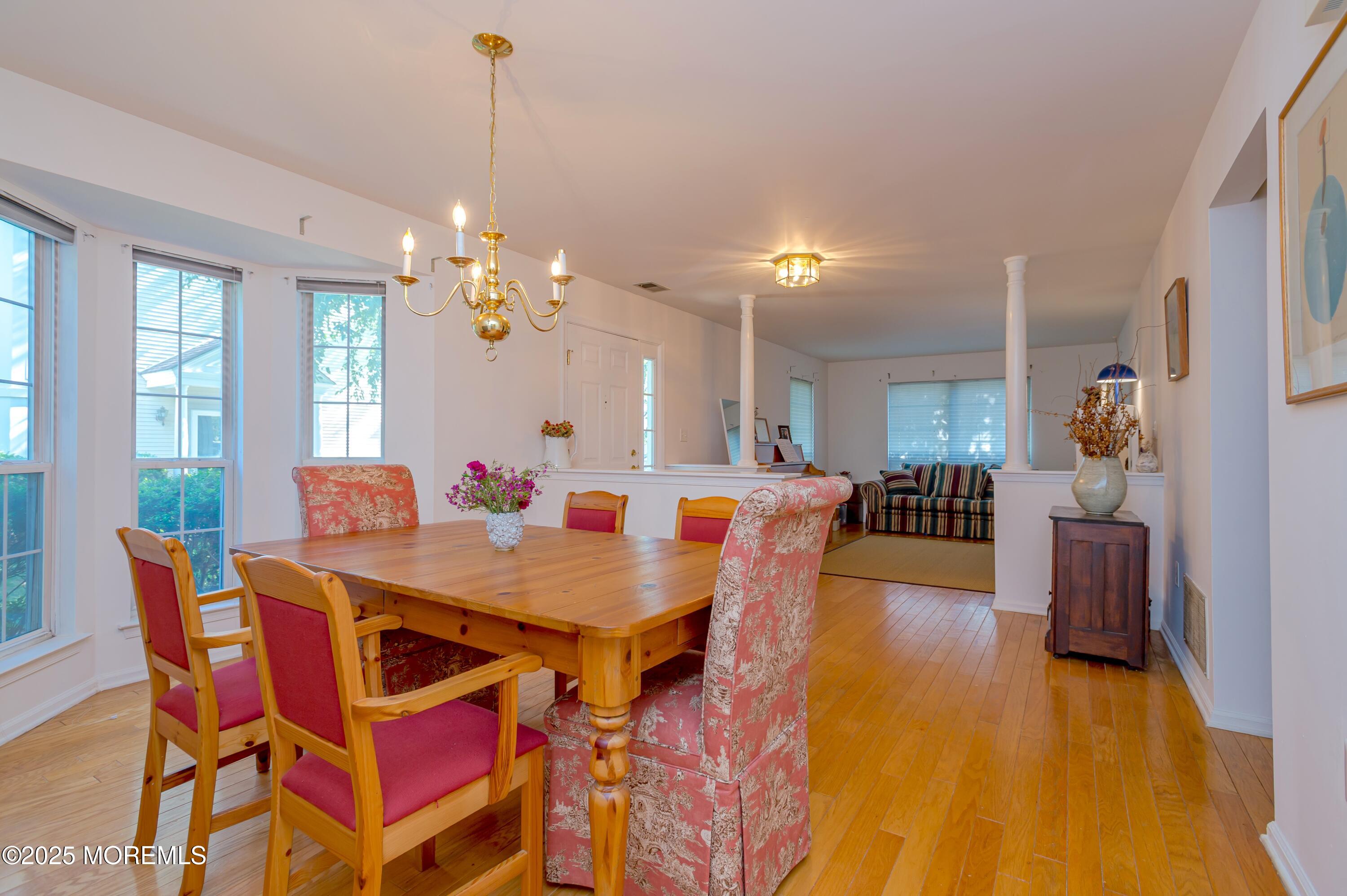 139 Tanya Circle, Unit 5506 Asbury Park, NJ 07712 - Photo 8 of 31 a view of a dining room with furniture and wooden floor