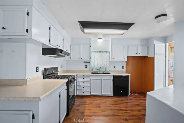 a kitchen with stainless steel appliances a stove refrigerator sink and cabinets