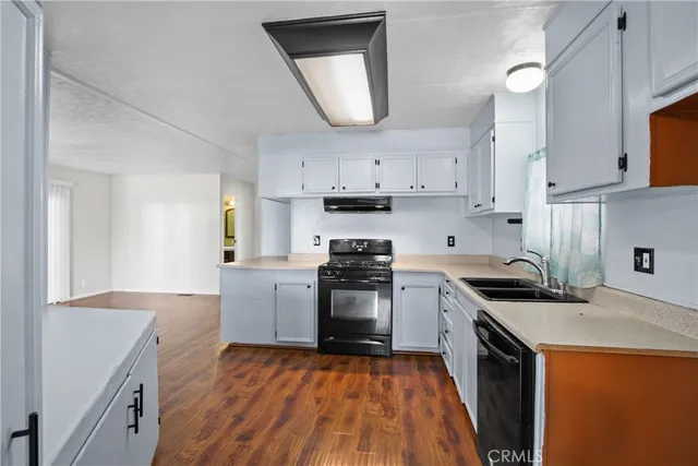 a kitchen with a stove a sink and a refrigerator