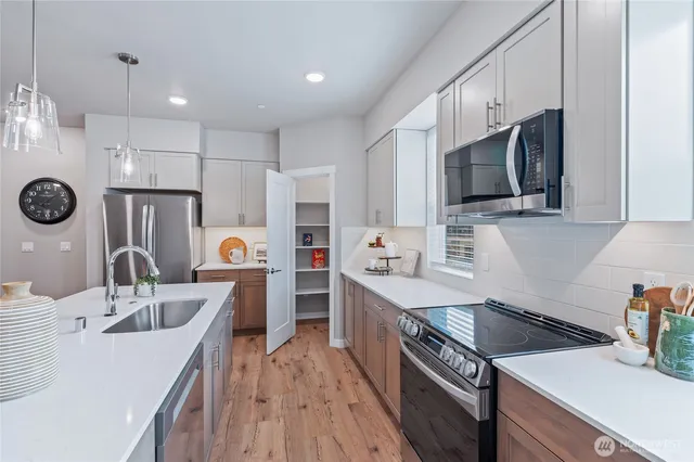 a kitchen with a sink a stove and refrigerator