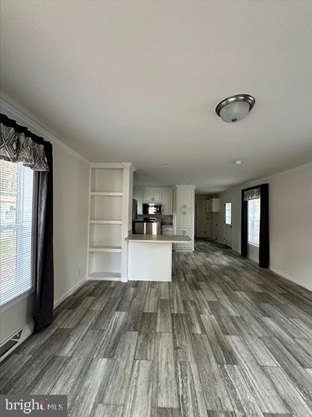 1679 South State Street, Unit A57 Dover, DE 19901 - Photo 14 of 25 a view of a living room hardwood floor and a kitchen with wooden floor
