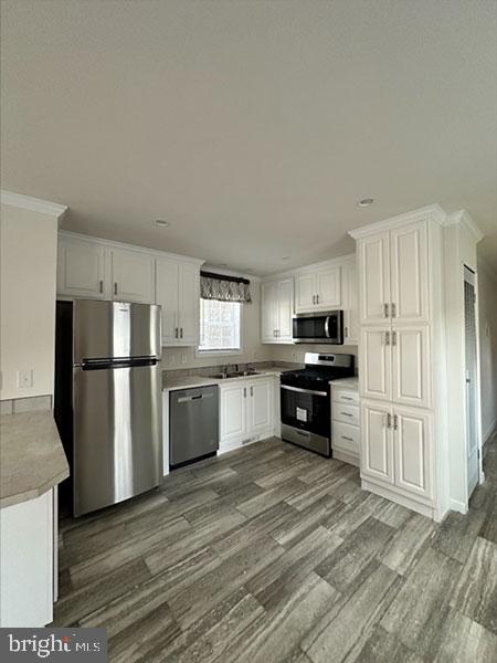 1679 South State Street, Unit A57 Dover, DE 19901 - Photo 19 of 25 a kitchen with granite countertop a refrigerator and a stove top oven