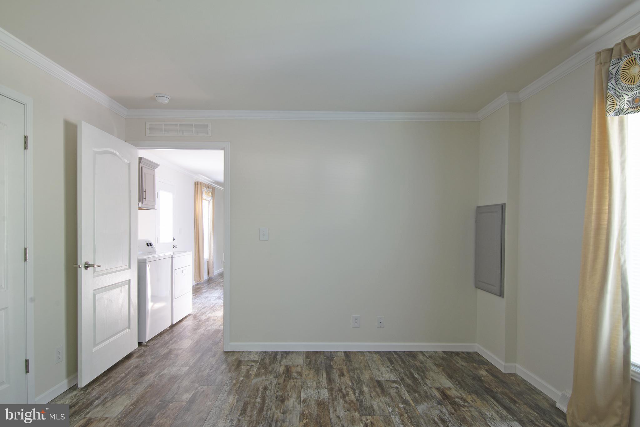 1679 South State Street, Unit A57 Dover, DE 19901 - Photo 6 of 25 a view of a room with wooden floor and a window