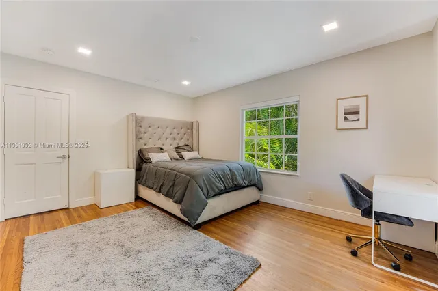 a bedroom with a bed and a chair