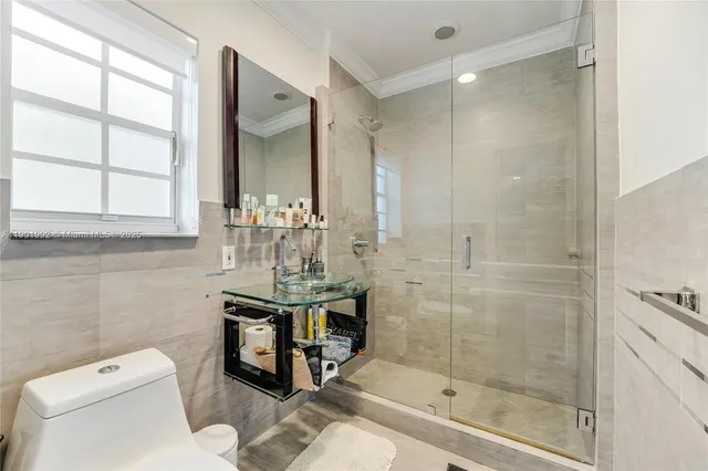 a bathroom with a toilet a sink and shower