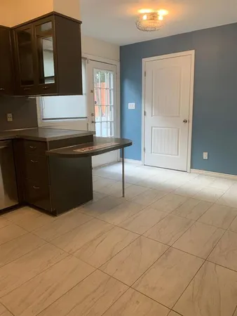 a room with a table and refrigerator