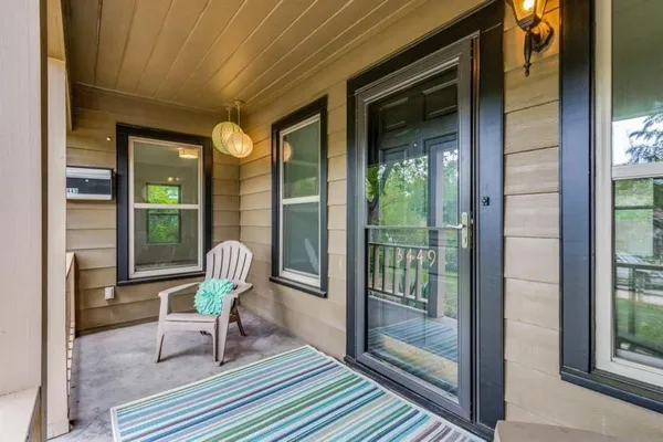 a view of a porch with chairs and backyard