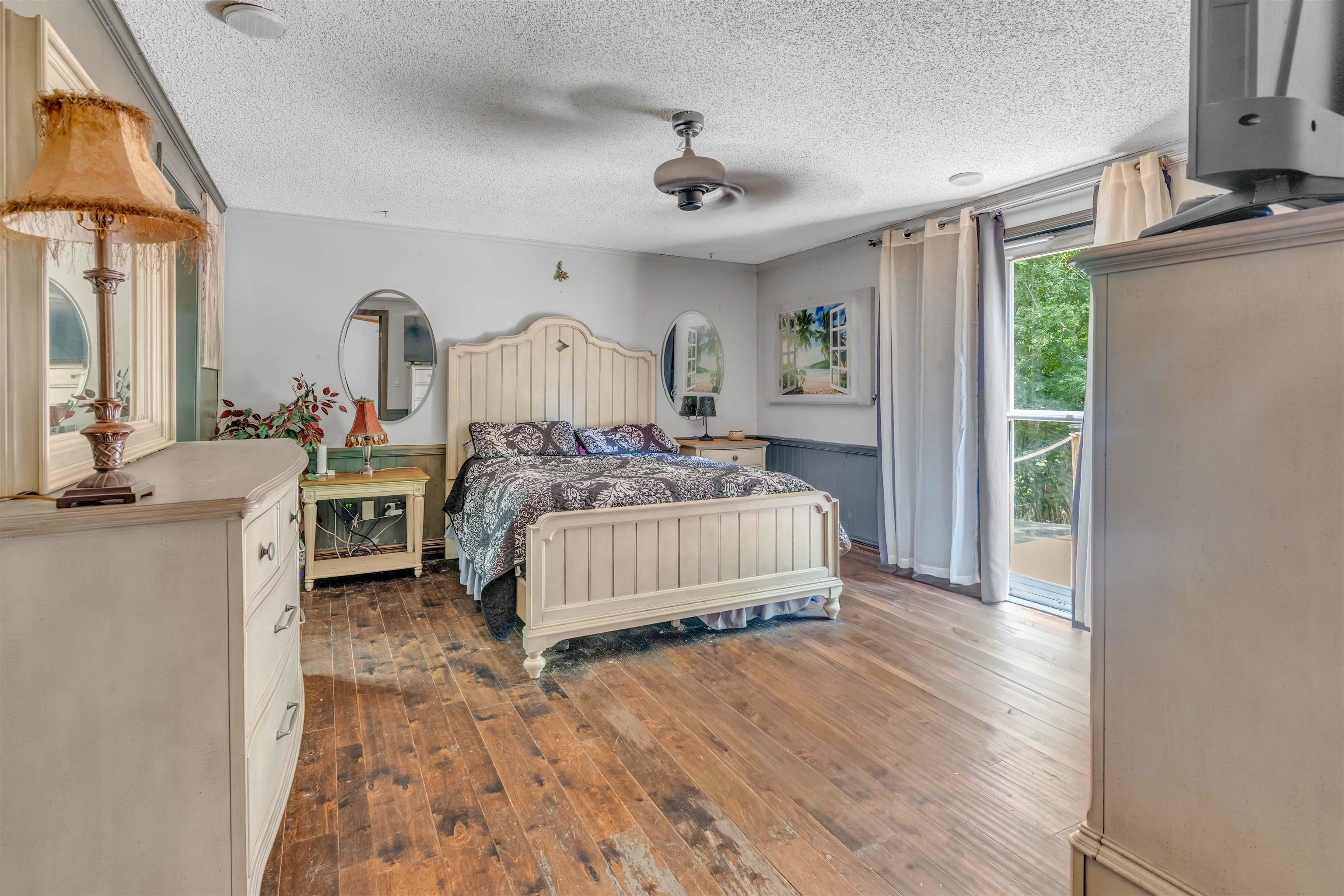 328 Cates Road Halls, TN 38040 - Photo 16 of 36 Wood-finish flooring throughout, ceiling fan with integrated lighting, built-in window valance, and sliding glass door