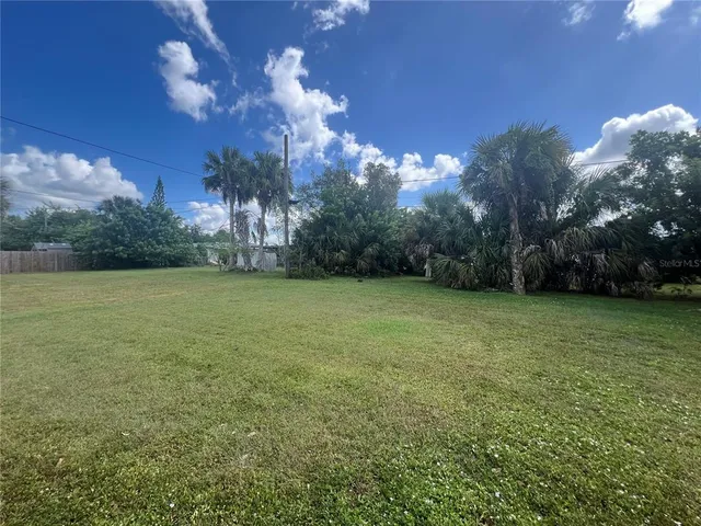 a view of a garden with a building in the background