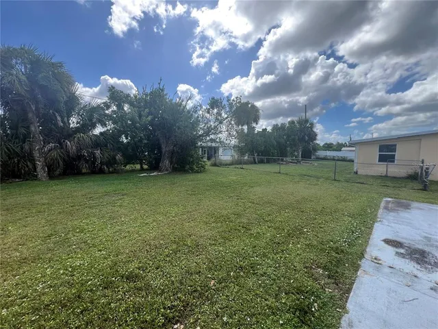 a view of a field of grass and trees