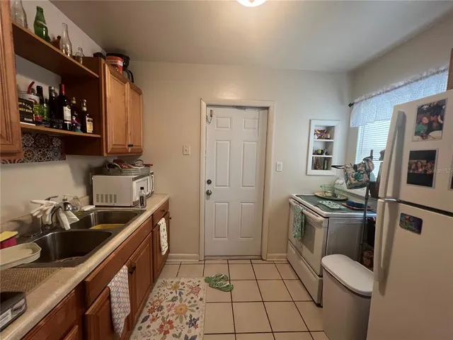 a kitchen with a sink appliances and cabinets