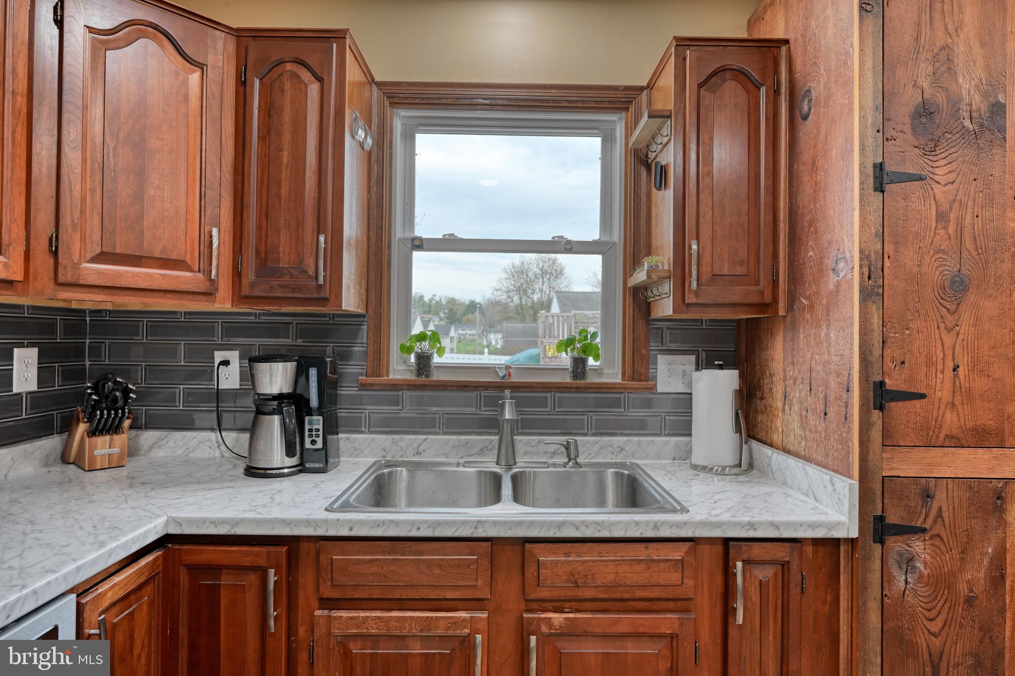 3320 Rothsville Road Akron, PA 17501 - Photo 13 of 41 a kitchen with granite countertop a sink a window and cabinets