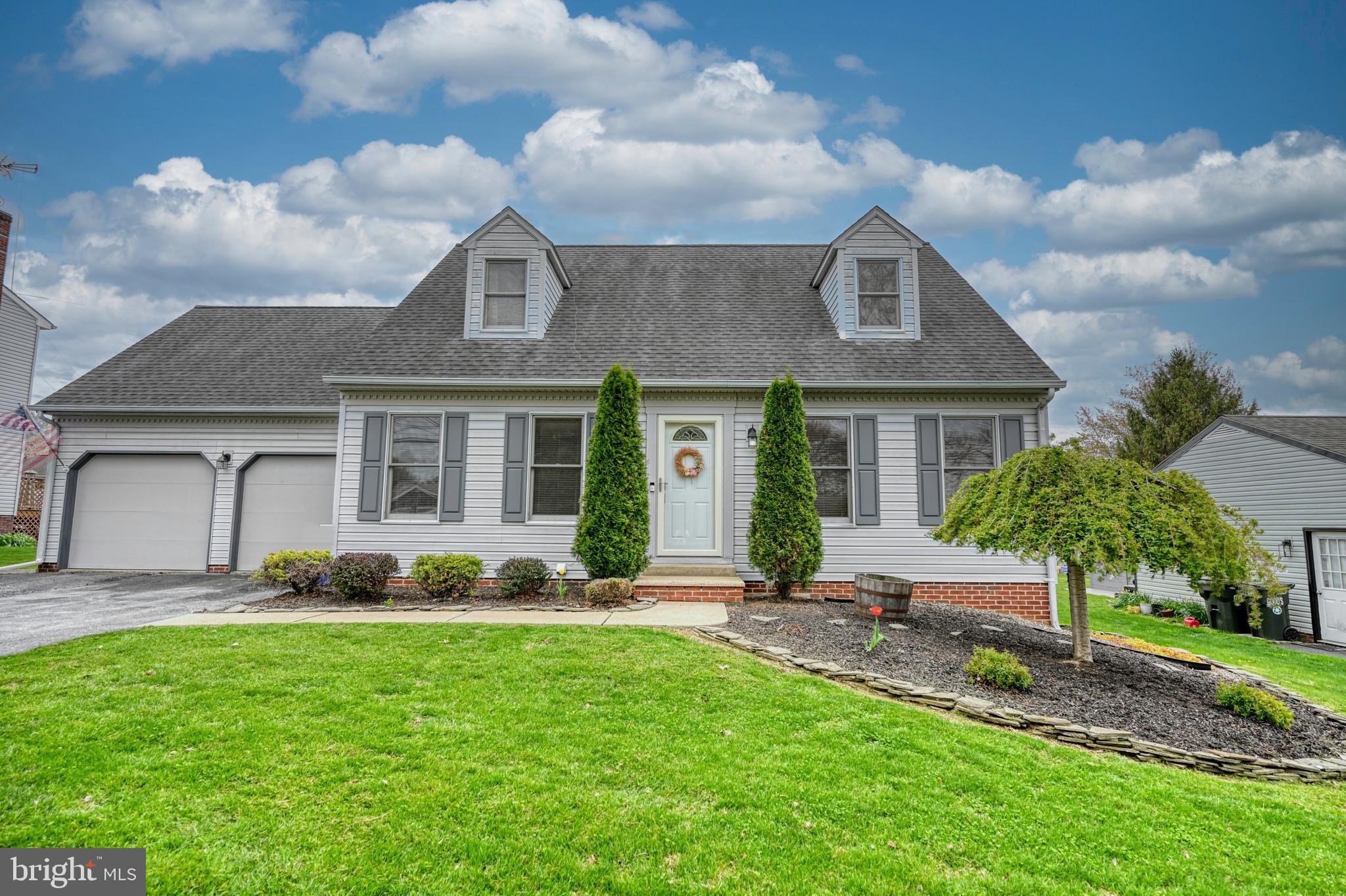 3320 Rothsville Road Akron, PA 17501 - Photo 30 of 41 a front view of a house with a garden and plants