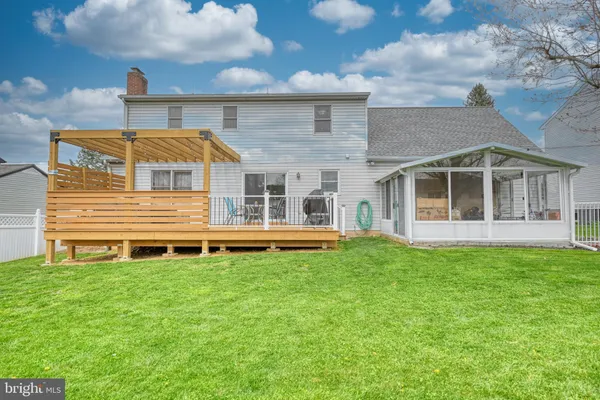a view of a house with a backyard