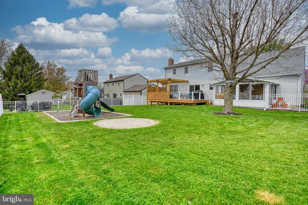 a view of a house with a backyard porch and sitting area