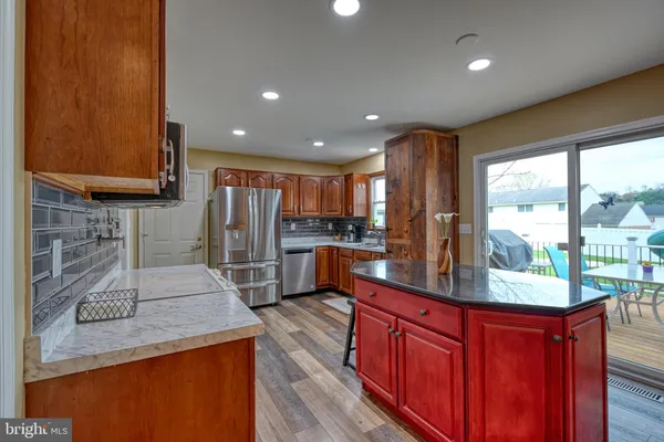 a kitchen with large windows and refrigerator