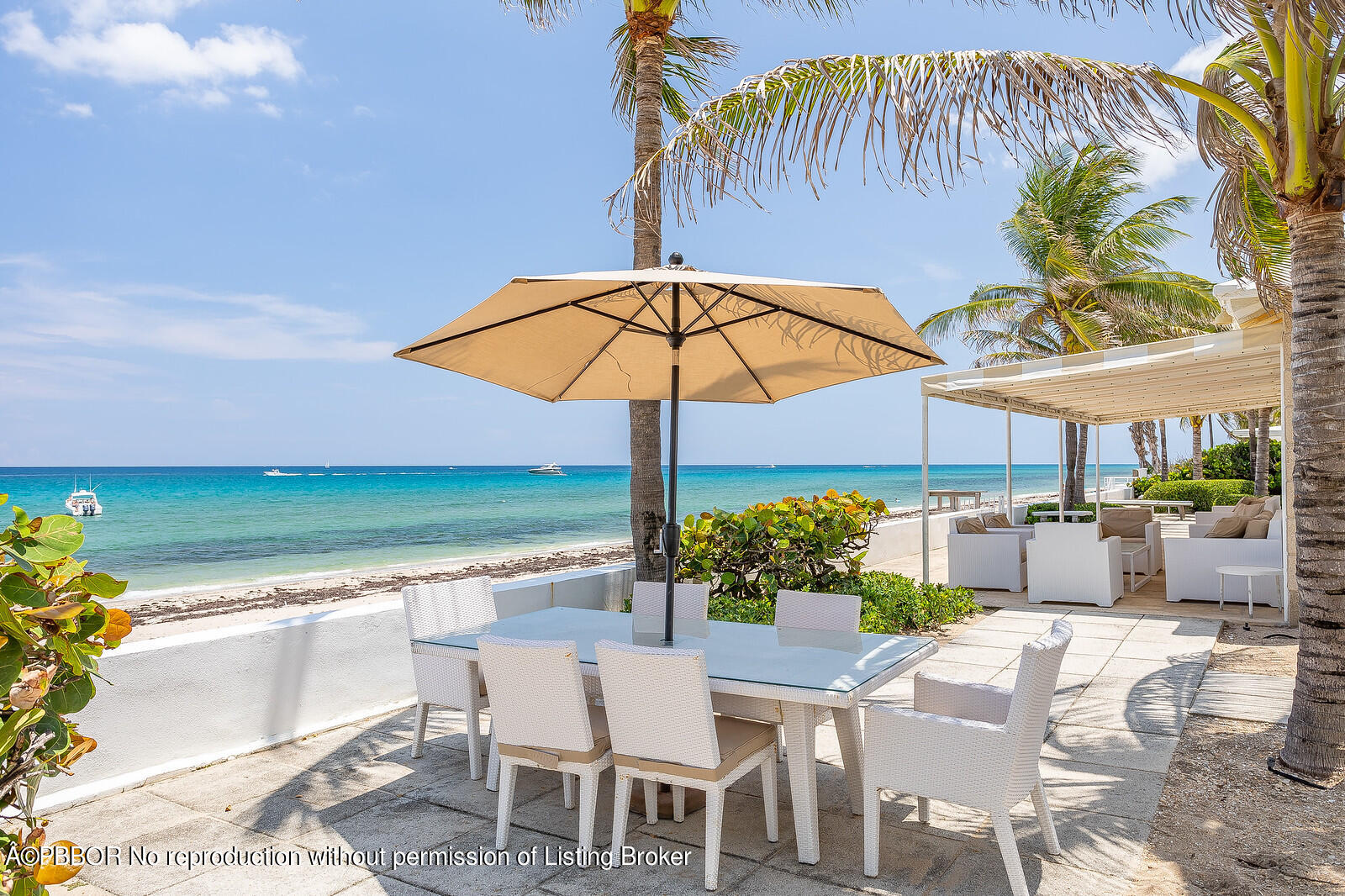 232 Mockingbird Trail Palm Beach, FL 33480 - Photo 12 of 14 a patio with a patio table and chairs