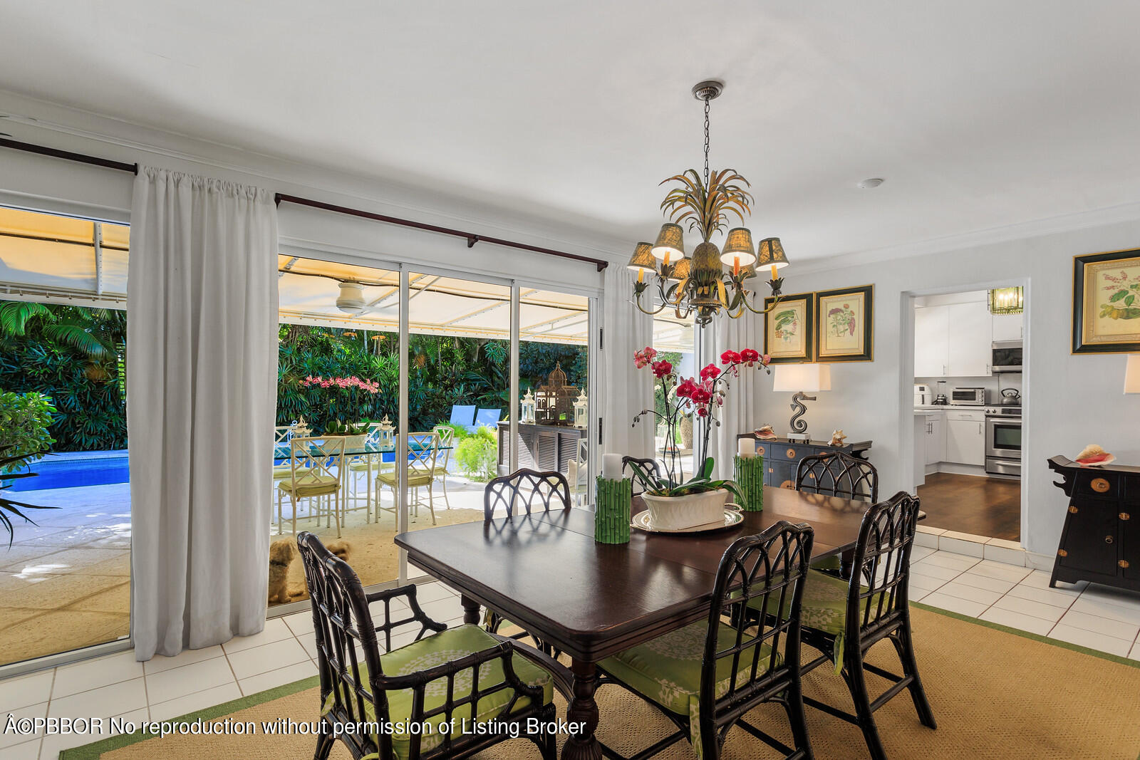232 Mockingbird Trail Palm Beach, FL 33480 - Photo 4 of 14 a dining room with wooden floor a chandelier a wooden table and chairs