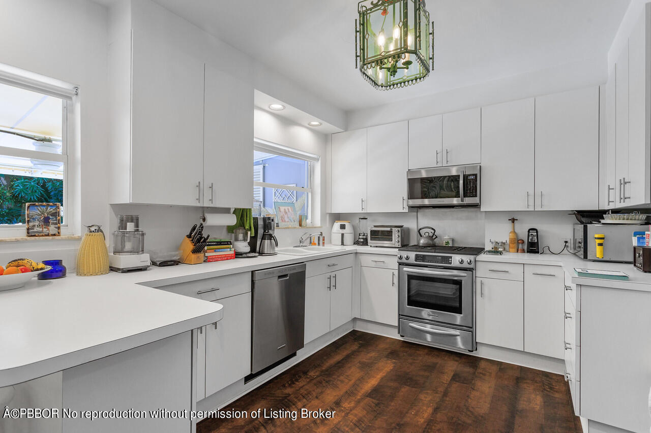 232 Mockingbird Trail Palm Beach, FL 33480 - Photo 5 of 14 a kitchen with a sink cabinets and window