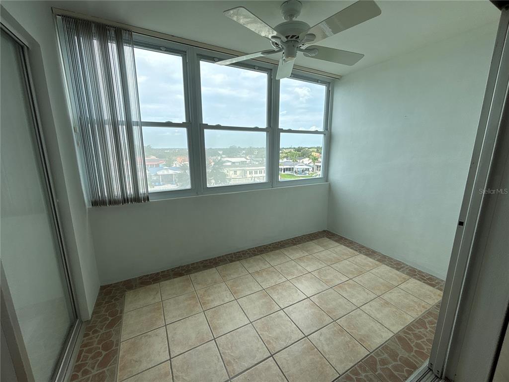 4725 Cove Circle, Unit 405 St. Petersburg, FL 33708 - Photo 11 of 23 an empty room with windows